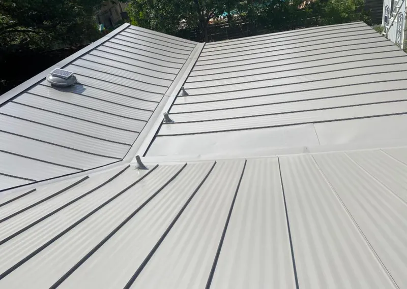 Solar attic fan installed on a metal roof for Roof Ventilation in Gibsonville